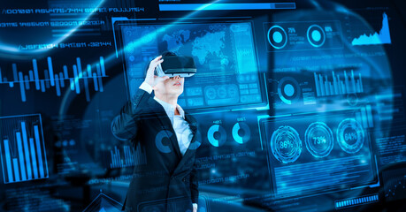 Project manager with VR goggles looking financial chart and glowing blue light at office. Skilled businessman checking and planning marketing strategy by using data from augmented reality. Ingenuity.