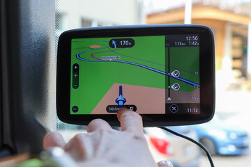 truck navigation close up.The driver selects a route for the truck