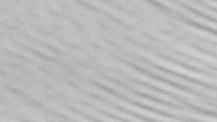 A close up grayscale image showing abstract patterns of light and shadow with subtle textures visible