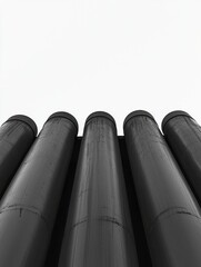 Group of six tall, cylindrical pipes or cylinders arranged in a row. the pipes are black in color and appear to be made of metal or a similar material.