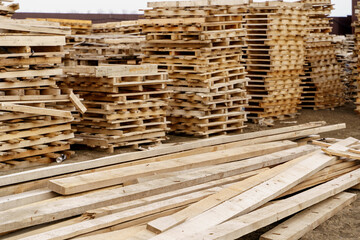 stack of wooden planks and pallets on the construction site 