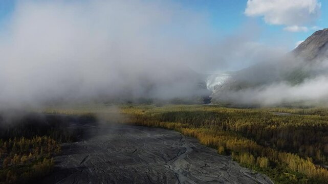 Drone footage of the scenic Kenai Fjords National Park covered with fog in Seward, Alaska, USA