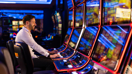 Man Enjoying Slot Machines in a Vibrant Casino Environment