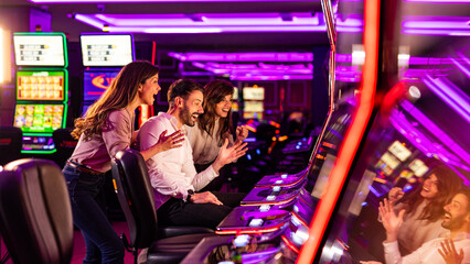 Group of Friends Celebrating at a Casino With Slot Machines © Dragana Gordic