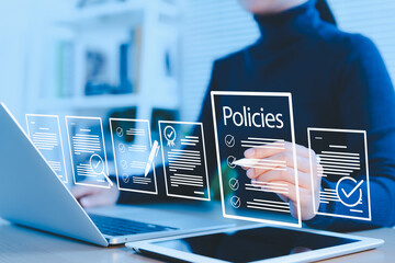 Policy documentation and compliance concept. Businesswoman reviews digital document Policies with...
