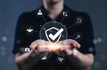 Work safety and compliance management concept. A person holds a shield check surrounded by safety,...