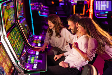 Group of Friends Enjoying Slot Machines in a Lively Casino Environment