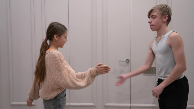 Two young friends or siblings share joyful moments through fist bumps and a secret handshake, showcasing connection, friendship, and youthful energy