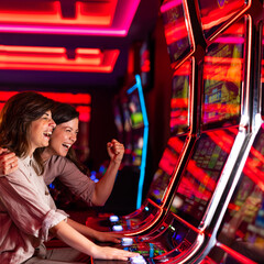 Excited Friends Enjoying Slot Machines in a Vibrant Casino Setting