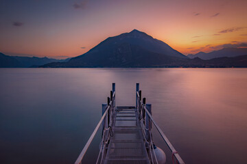 Lago di Como, Lake Como. Beautiful sunset with clouds in Alps mountains. Epic blue lake near Milan, mountain, villa, forest, colorful flowers. Premium landscape from pure nature, Lombardy, Italy