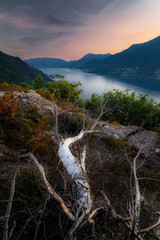 Lago di Como, Lake Como. Beautiful sunset with clouds in Alps mountains. Epic blue lake near Milan, mountain, villa, forest, colorful flowers. Premium landscape from pure nature, Lombardy, Italy