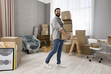 Moving day. Man with cardboard boxes in his new home