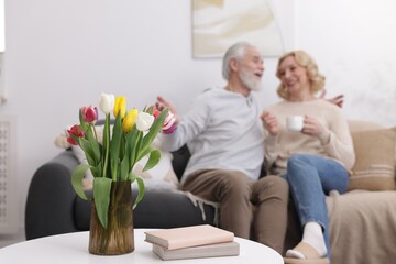 Fototapeta premium Senior man and mature woman spending time together at home, selective focus. Happy couple