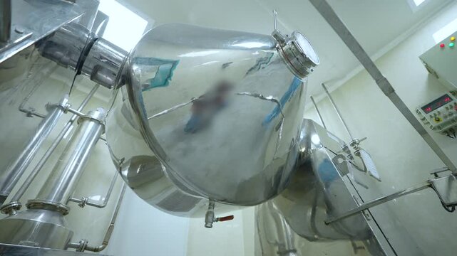 pharmaceutical large machines making medicines in cleanroom stainless steel equipment with pharma grademachinery boxes in a pharmaceutical factory for manufacturing. Co packer 