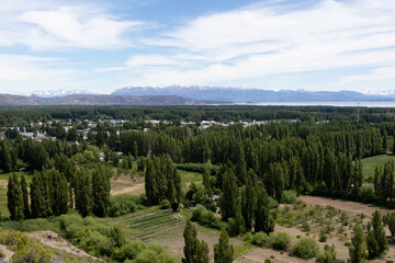 City of Los Antiguos surrounded by cypress trees photographed from above - mountains and Lake Buenos Aires