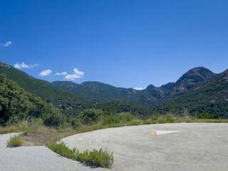 Corsica, France - July 8, 2024: Green mountain landscape. From Ocana to Ajaccio, along Road D3 is a lookout parking and helicopter landing spot