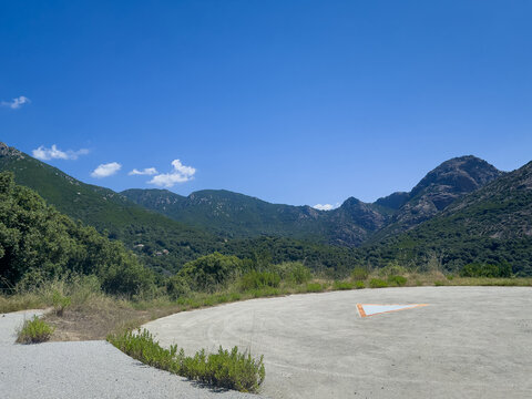 Corsica, France - July 8, 2024: Green mountain landscape. From Ocana to Ajaccio, along Road D3 is a lookout parking and helicopter landing spot