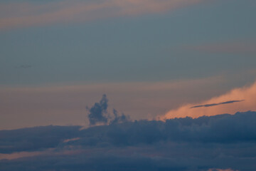 Summer blue sky with  white and gray clouds hiding the sun. Winter weather before the storm. Spring...