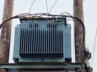 Mounted Electrical Transformer on Wooden Utility Poles Outdoors