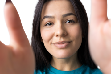 Portrait of attractive young woman wants to hug you, isolated on grey background.