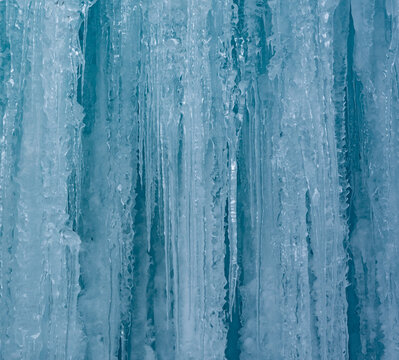 Cold winter icicles melting banner. Blue frozen ice close-up photograph. 	