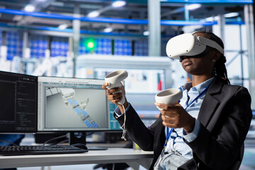 Photovoltaics factory expert creates CAD models for solar modules using virtual reality. Woman uses...
