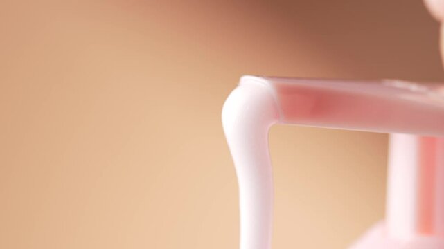 Squeezing foam from the bottle. Soap, foam shower, hair foam mousse, shaving gel foam, macro.