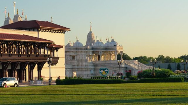 BAPS Shri Swaminarayan Mandir Hindu temple in Toronto at sunset with golden sky