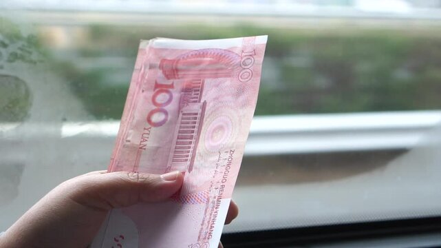yuan banknotes Chinese currency (Renminbi or RMB) featuring 100-yuan banknote with Mao Zedong's. Counting cash money one hundred Chinese yuan bills for goods services, Cash in car
