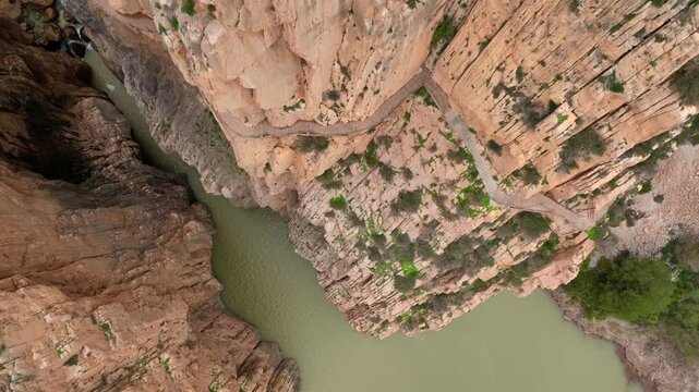 Caminito del Rey in Garganta Gorge, del Chorro, Spain. Aerial shot of a bridge in a narrow gorge, a river flows below. 