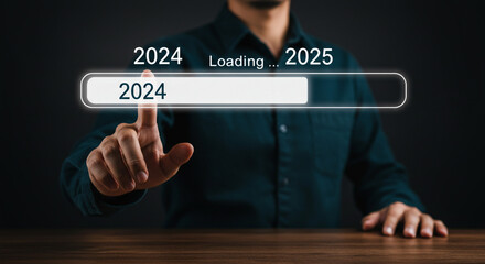 Loading 2025: A person initiates the transition to the new year, a hopeful anticipation for the future unfolding before them with a sleek digital interface.