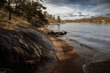 Rocky shore of a lake on a warm spring day