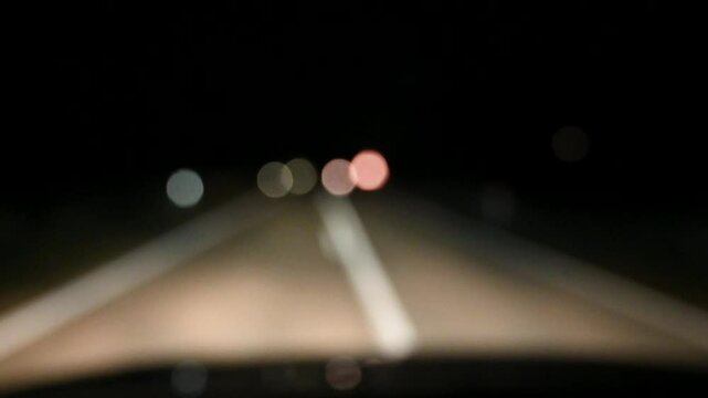 The blurred vision of a drunk driver in dangerous driving. A drunk driver drives a car at night. Dangerous driving. Driver loosing control. 