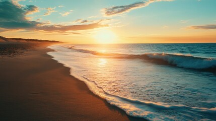 Obraz premium A serene image of a beach at sunset with the warm colors of the sky reflecting on the ocean.