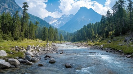 Obraz premium Mountain river winding through verdant meadows, framed by towering peaks and evergreen forests, revealing untouched wilderness landscape