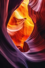 Colorful rock formation with smooth curves and shades of orange, pink, and purple