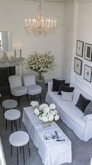 Elegant minimalist living room with white sofa, armchairs, coffee table, and floral arrangements