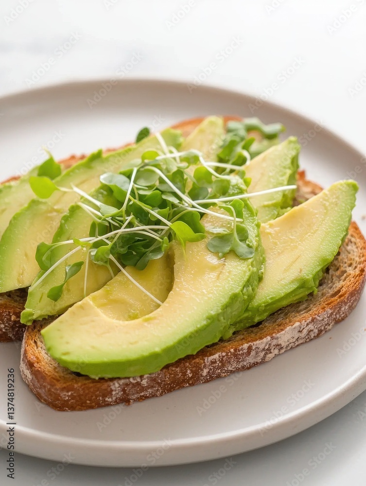 Poster slice of toast on a white plate. the toast is made with two slices of dark brown bread and is topped