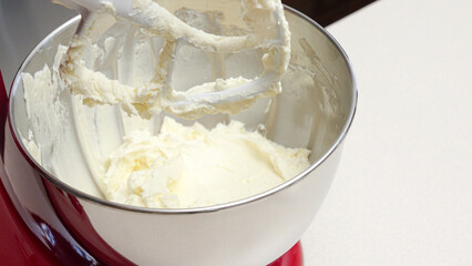 Vibrant Red Stand Mixer with Stainless Steel Bowl Mixing Yellow Batter