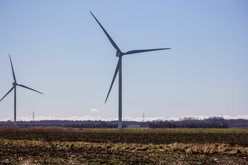 Wind Turbines Over a Brown Field Under a Clear Blue Sky