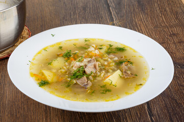 Dill added to freshly prepared Leningrad-style rassolnik soup.