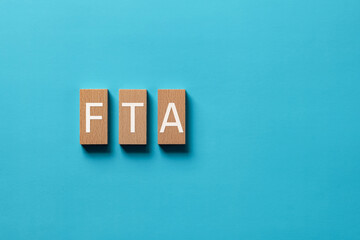 There is wood block with the word FTA. It is an abbreviation for Free Trade Agreement as...