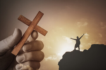 Strength in religious belief. Hand holding cross, Woman on mountain top overcoming hardship life difficulties with strong belief, faith in god.
