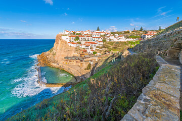 View from the cliffside walking trail of the scenic seaside town of Azenhas do Mar, Portugal, along...