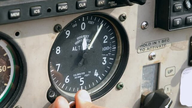 The pilot sets the pressure settings QNH on the altimeter instrument in the cockpit of the aircraft. Concept of reliability of aviation instruments