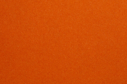 The orange background is a solid color with no pattern, textured origami paper backdrop