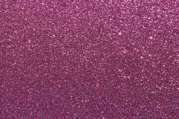 A close up of a pink glittery surface