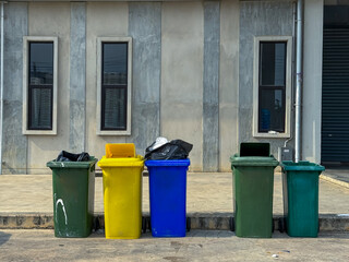 Different color of garbage near the building