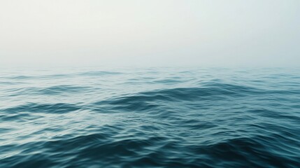 Obraz premium Serene Ocean Vista with Gentle Waves and Soft Misty Background Horizon A Calming Marine Landscape in Blues and Whites