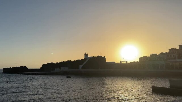 sunset over the ocean and old town camera de lobos madeira